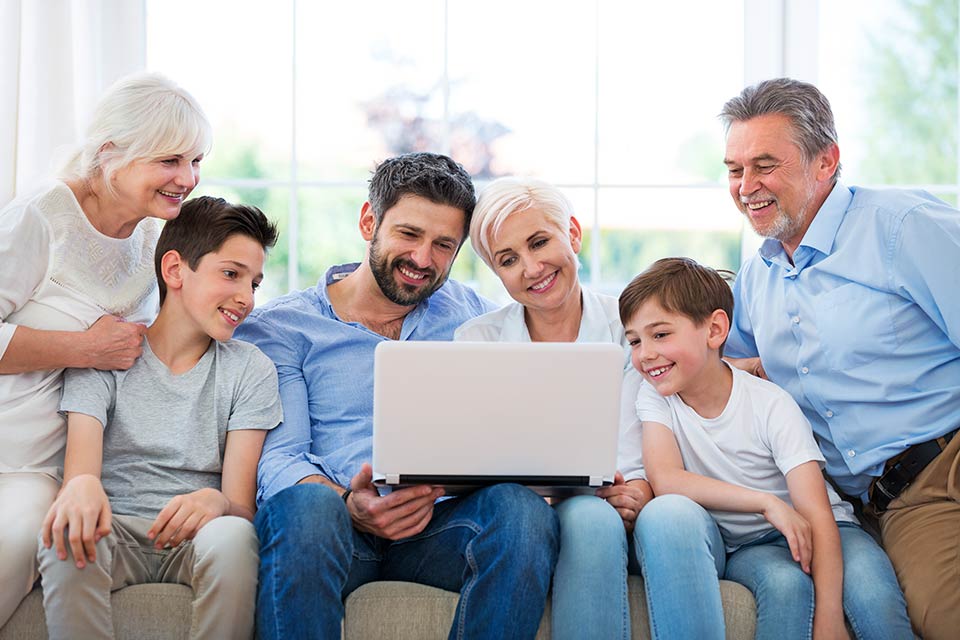 family of six looking at laptop computer