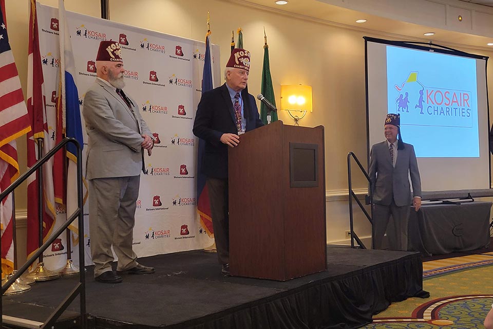 three Shriners at Kosair conference, Kosair Charities logo, Shriners International logo